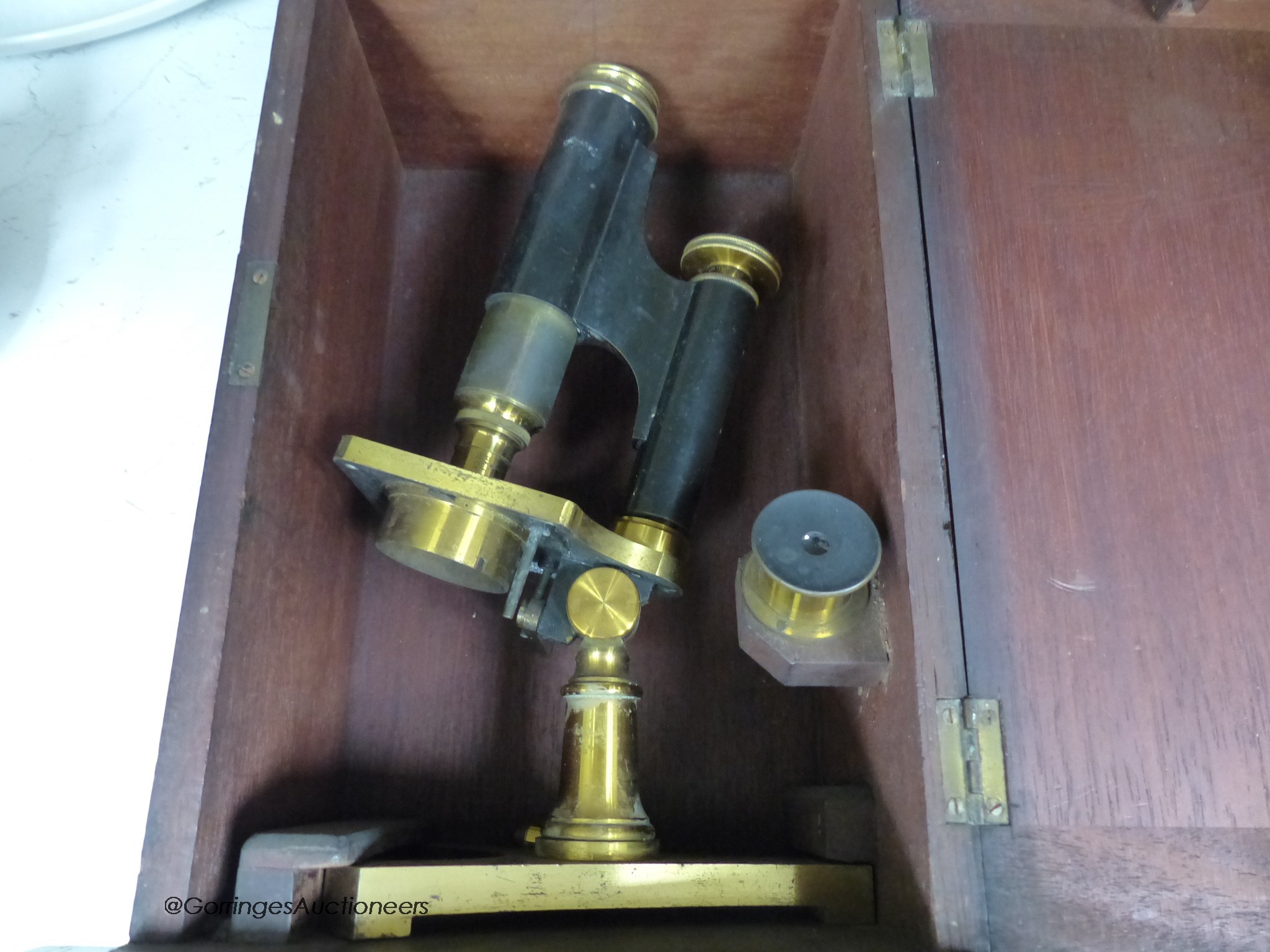 Three mahogany cased travelling microscopes and cased lenses